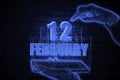 February 12th. A hand holding a phone with a calendar date on a futuristic neon blue background. Day 12 of month.