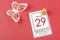 February 29th mini calendar for February 29 and wooden push pin on red background