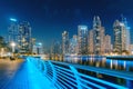 Neon illuminated embankment in the Dubai Marina district with numerous skyscrapers in the evening. Royalty Free Stock Photo
