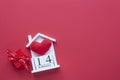 14 February wooden house calendar on a red heart background. Happy ValentineÃ¢â¬â¢s Day top view card