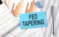 FED TAPERING text on the sticker on diagram background