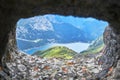 Fedaia Lake in Dolomites mountains, Italy, as seen through a crenel from an old war tunnel Royalty Free Stock Photo