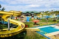 FEDERACION, ENTRE RIOS, ARGENTINA. Girl having fun in the yellow water slide in foreground. The aquatic park in