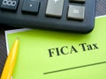Federal Insurance Contributions Act FICA tax papers and calculator.