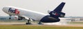 A FedEx Airplane touches down at the airport. Royalty Free Stock Photo