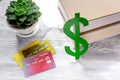 Fee-paying education set with dollar sign, books and cards on light table background Royalty Free Stock Photo