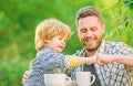 Feed baby. Natural nutrition concept. Fathers day. Best friends. Father and son having fun. Feeding son natural foods Royalty Free Stock Photo