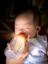 Feed milk baby in mother hand Royalty Free Stock Photo