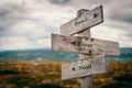 Feed your soul text on wooden rustic signpost outdoors in nature/mountain scenery.