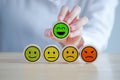 Hand choosing happy smiling face. Feedback rating and positive service review. Royalty Free Stock Photo