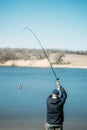 Feeder fishing. Carp Fishing Steel Basket Bait Feeder on rod close up. Male fisherman fishing at sun day on the lake Royalty Free Stock Photo