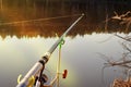 Feeder fishing rod on the stand against the background of the river. Closeup Royalty Free Stock Photo