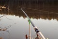 Feeder fishing rod on the stand against the background of the river. Closeup Royalty Free Stock Photo