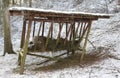 Feeder with hay for forest wild animals for winter in snowy for Royalty Free Stock Photo