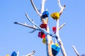 Feeders for birds are attached to a tree made of metal