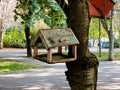 Feeders for birds in the city park. Concept of helping animals