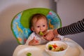 Feeding baby - adorable boy eating broccoli Royalty Free Stock Photo