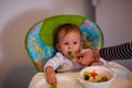 Feeding baby - cute boy eating chocolate Royalty Free Stock Photo