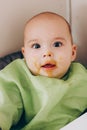 Feeding the baby. Happy smiling baby with dirty face Royalty Free Stock Photo