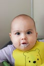 Feeding the baby. Happy smiling baby with dirty face Royalty Free Stock Photo