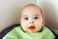 Feeding the baby. Happy smiling baby with dirty face Royalty Free Stock Photo