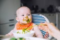 Feeding. Baby& x27;s first solid food Royalty Free Stock Photo