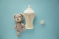 Feeding bottle of baby formula with pacifier and toy on color background Royalty Free Stock Photo