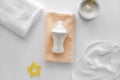 Feeding bottle of baby formula with powder and towels on white background Royalty Free Stock Photo