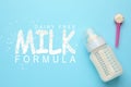Feeding bottle with dairy free infant formula and powder on light blue background, flat lay. Baby milk Royalty Free Stock Photo