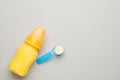 Feeding bottle with infant formula and powder on light background, flat lay. Space for text Royalty Free Stock Photo