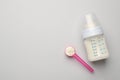 Feeding bottle with infant formula and powder on light background, flat lay. Space for text Royalty Free Stock Photo