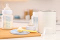 Feeding bottle with infant formula and powder on white table indoors Royalty Free Stock Photo