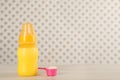 Feeding bottle with infant formula and scoop of powder on white wooden table, space for text. Baby milk Royalty Free Stock Photo