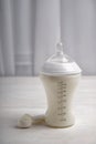 Feeding bottle of milk for baby with powder on white table Royalty Free Stock Photo