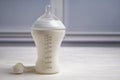 Feeding bottle of milk for baby with powder on white table Royalty Free Stock Photo