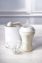 Feeding bottle of milk for baby with powder on white table Royalty Free Stock Photo