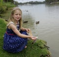 Young Girl Feeding Ducks In The Murray River, Mild Royalty Free Stock Photo