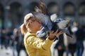 Feeding the pigeons in Milan square, Italy, 04 09 2017