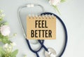 Feel Better on the white card with the stethoscope. Medical concept photo Royalty Free Stock Photo