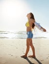 Feel free to live a little. a beautiful young woman enjoying her day at the beach. Royalty Free Stock Photo