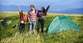 Feel freedom. Man and girls having fun in nature. Camping tent. Happiness concept. Hiking activity. Friends set up tent