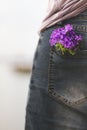 Feel like spring; woman holds a bouquet of colorful flowers in her pants pocket Royalty Free Stock Photo