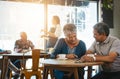 We feel more connected than ever before. a senior couple out on a date at a coffee shop.