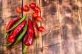 Feel the piquancy. Chili peppers and cherry tomatoes. Red and green vegetables. Organic vegetables Royalty Free Stock Photo