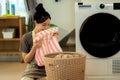 Feel softness, smiling asian young woman is smiling while doing laundry at home Royalty Free Stock Photo