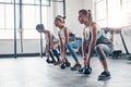 Feel it working in your core. three women working out with weights at the gym.