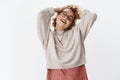 Feeling alive and carefree. Joyful relieved and relaxed good-looking stylish hipster woman in sweater and glasses laying