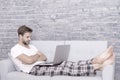 feeling comfortable. domestic lifestyle with mobile abuse. handsome man online dating. relaxed man on sofa. guy enjoying Royalty Free Stock Photo