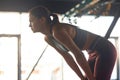 Feeling exhausted. Side view of a tired fitness woman resting after workout at gym, taking a break Royalty Free Stock Photo