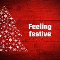 Feeling festive text with white snowflake christmas tree on red wood texture Royalty Free Stock Photo